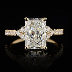 Front face view of 3 CT radiant cut lab grown diamond engagement ring with cluster side stones and pavé band in yellow gold