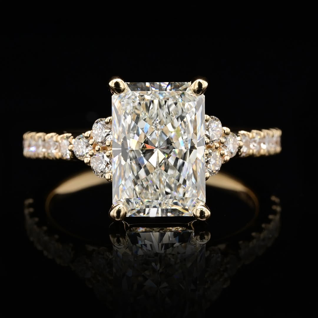 Front face view of 3 CT radiant cut lab grown diamond engagement ring with cluster side stones and pavé band in yellow gold