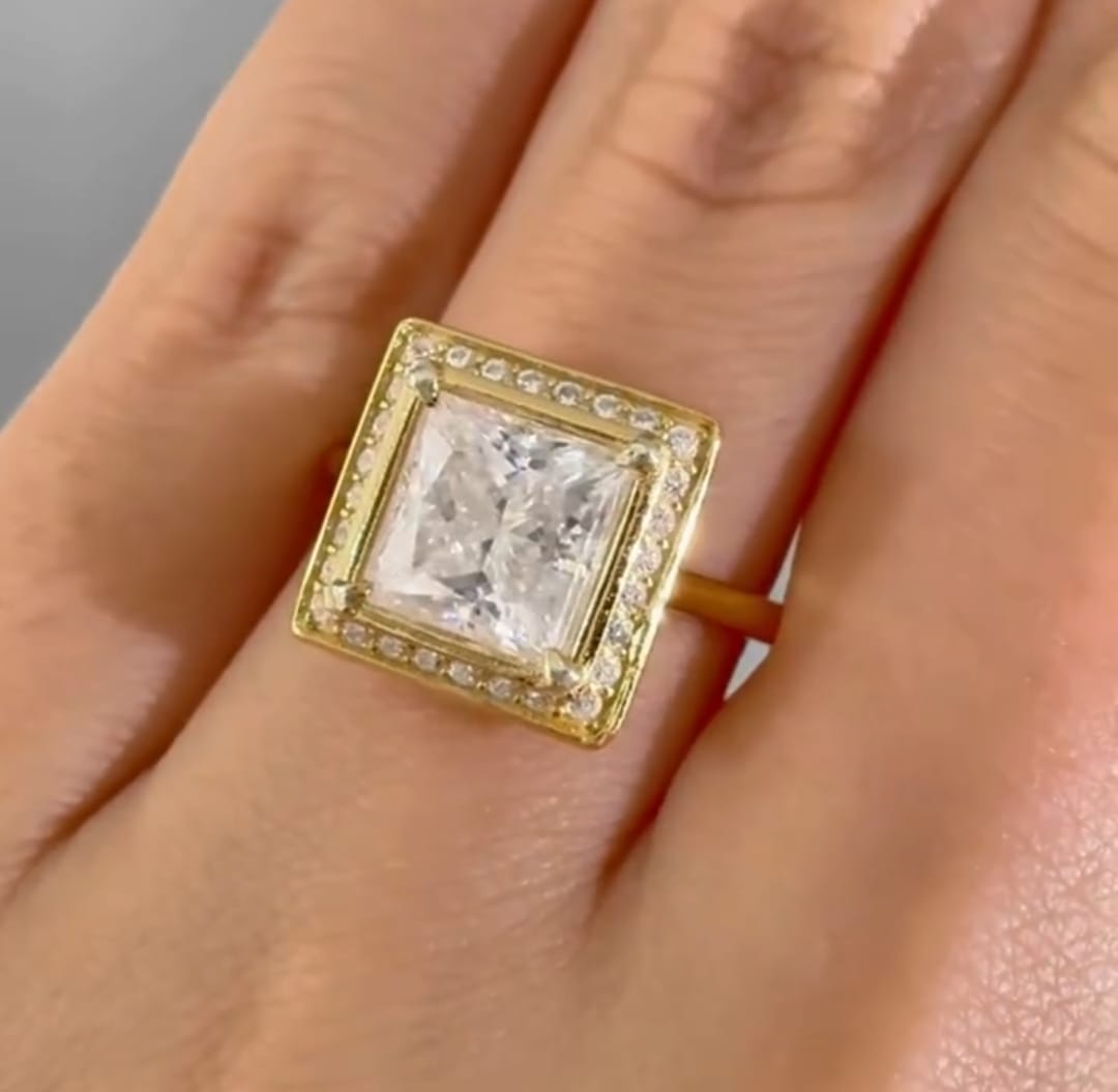 Top view on hand showing a 3 carat princess cut lab grown diamond ring in yellow gold