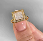 Detailed front view of a 3 carat princess cut diamond framed by a micro-pavé square halo