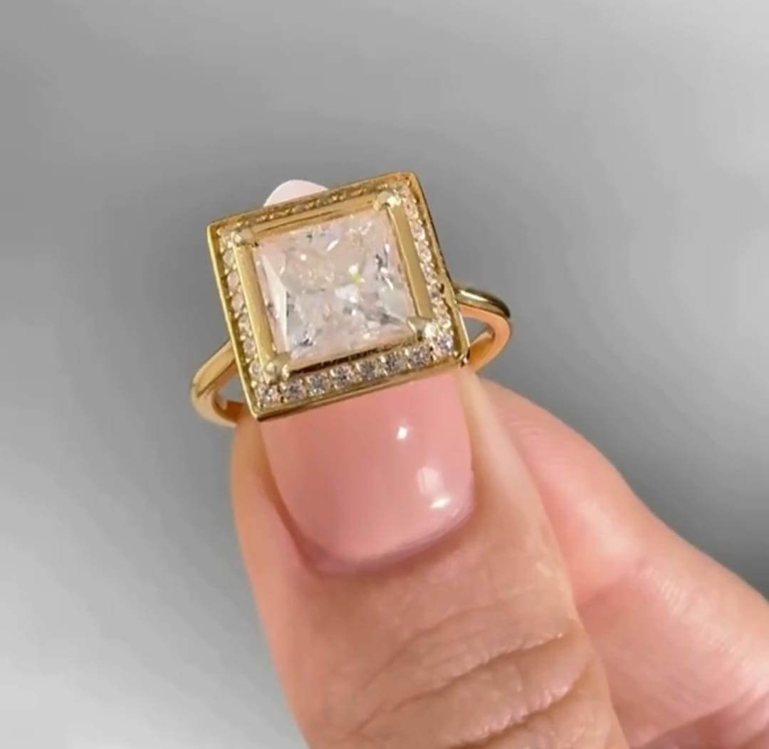 Detailed front view of a 3 carat princess cut diamond framed by a micro-pavé square halo