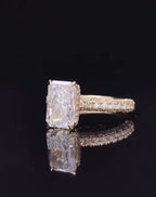 Angled studio shot of a 3 carat radiant cut lab diamond featuring a wide double row micro-pavé yellow gold band
