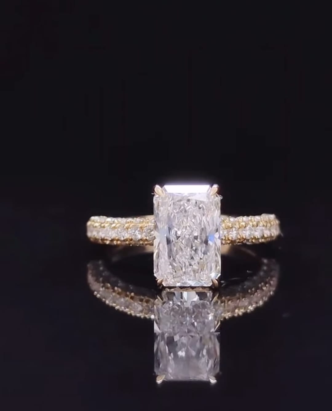 Direct front view of a 3 carat radiant cut lab grown diamond showing facets and multi-row micro-pavé band details