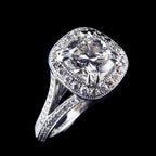 Angled view of a 3 CT cushion cut lab grown diamond engagement ring featuring a milgrain halo and split-shank pavé band in white gold