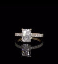 Direct front view displaying the brilliance and faceting of a 2 carat elongated radiant cut lab diamond on a yellow gold pavé band