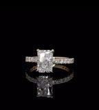 Direct front view displaying the brilliance and faceting of a 2 carat elongated radiant cut lab diamond on a yellow gold pavé band