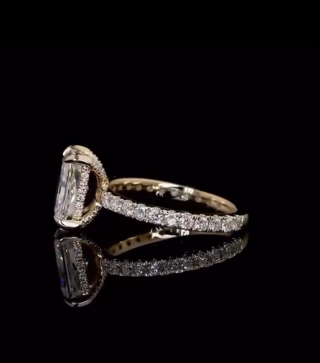 Angled studio reflection shot of a 2 CT elongated radiant cut lab diamond ring showing the side halo and band details