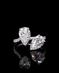 Front close-up view of a 3 CTW Toi et Moi two-stone pear cut lab grown diamond ring on a white gold pavé band
