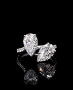 Front close-up view of a 3 CTW Toi et Moi two-stone pear cut lab grown diamond ring on a white gold pavé band