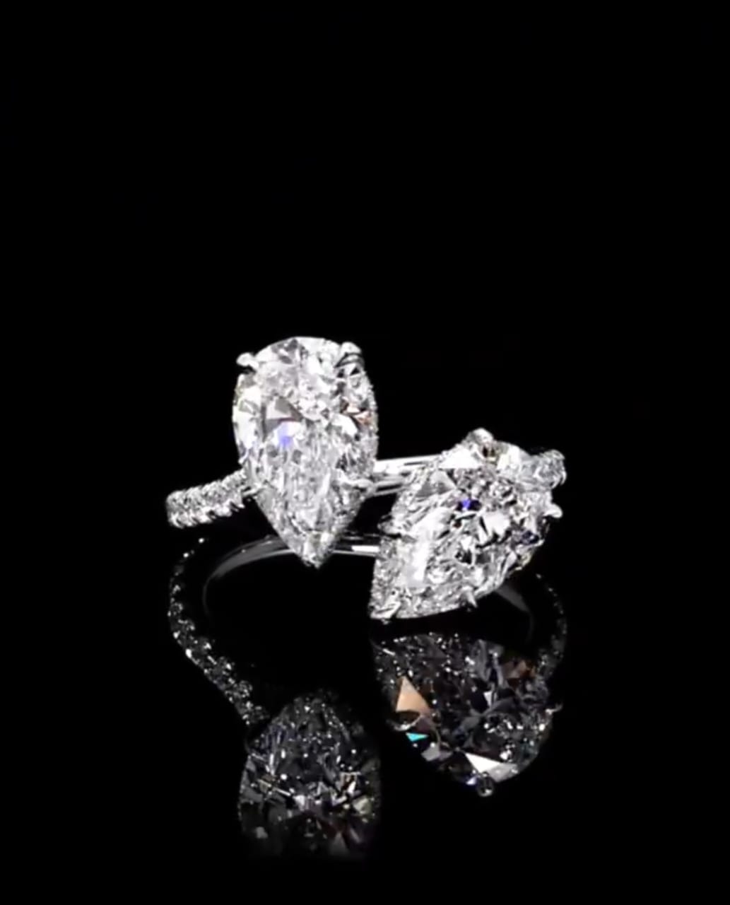 Front close-up view of a 3 CTW Toi et Moi two-stone pear cut lab grown diamond ring on a white gold pavé band