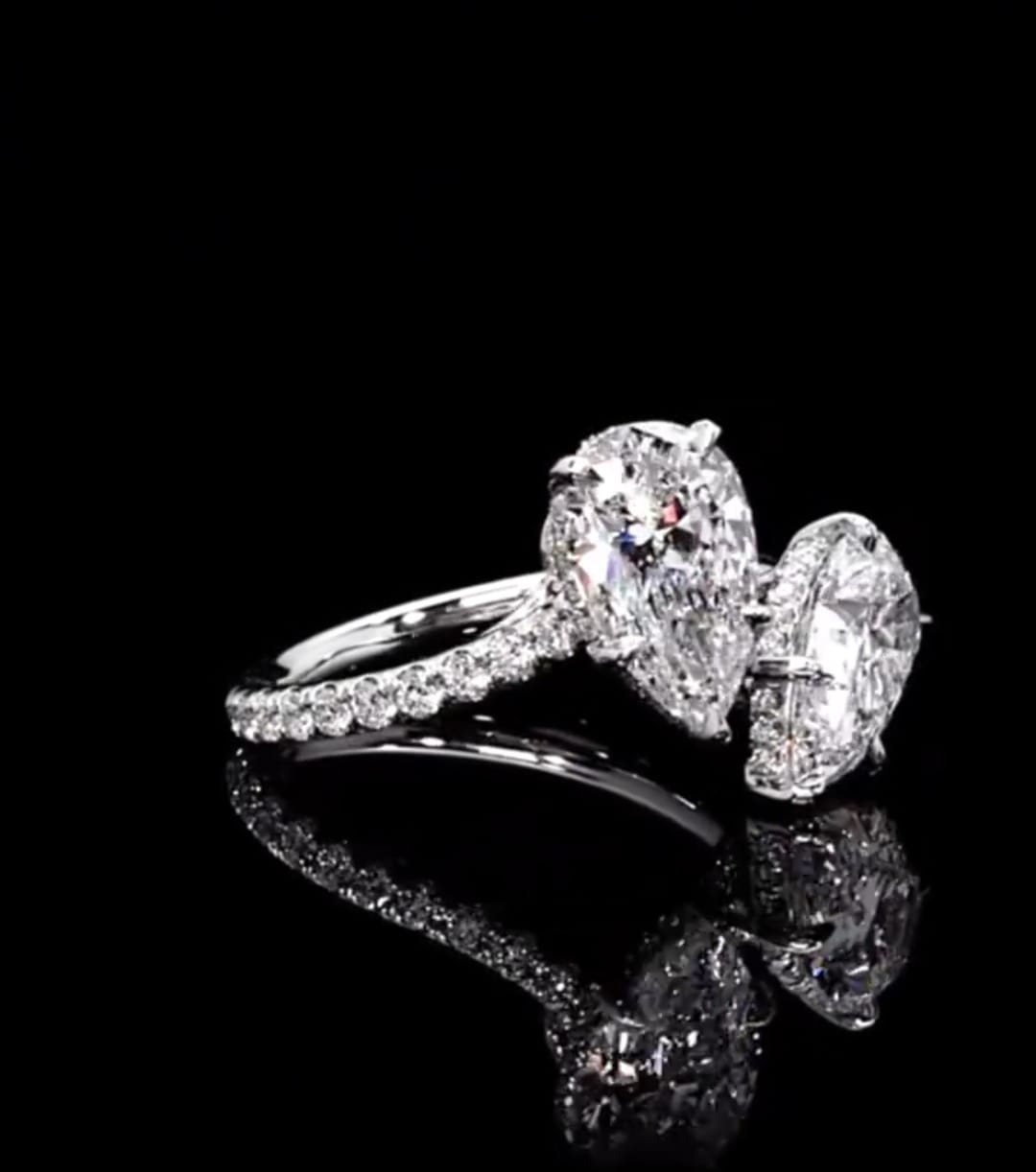 Angled perspective showing the hidden halo under-gallery on twin 1.5 CT pear cut lab grown diamonds