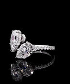 Side profile view of a two stone pear cut lab diamond Toi et Moi ring with micro-pavé band details