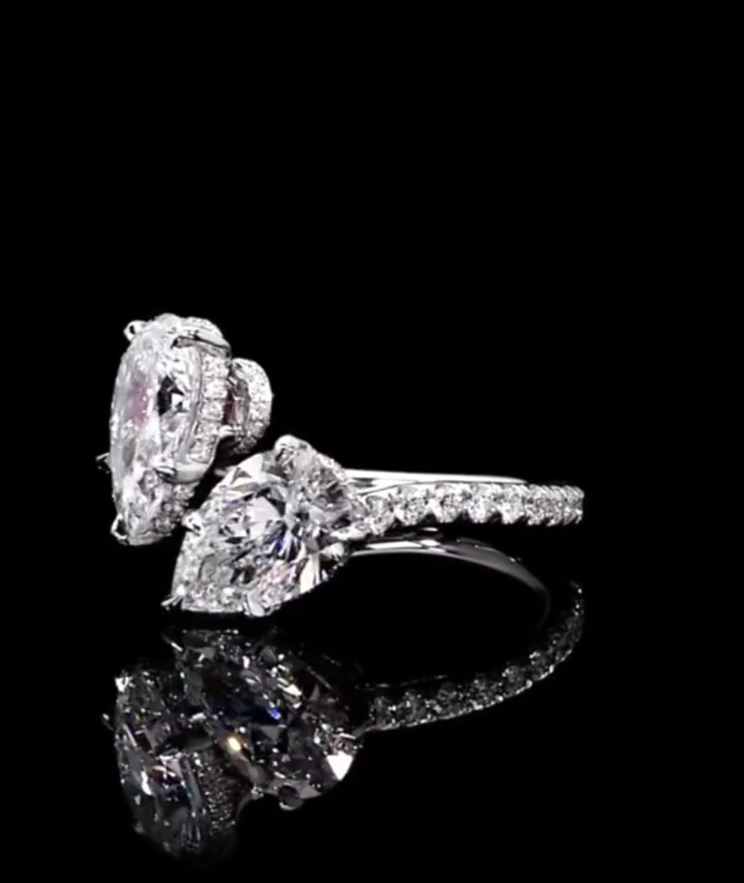 Side profile view of a two stone pear cut lab diamond Toi et Moi ring with micro-pavé band details