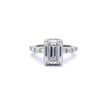 Top-down front view of a 3 CT emerald cut lab grown diamond ring with channel-set baguette band in white gold
