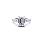 Top-down front view of a 3 CT emerald cut lab grown diamond ring with channel-set baguette band in white gold
