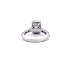Direct profile view showing the intricate filigree arch and diamond accents beneath the center stone basket