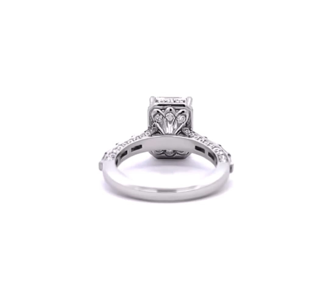 Direct profile view showing the intricate filigree arch and diamond accents beneath the center stone basket