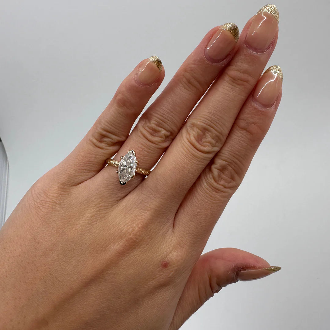 2 Carat Marquise Cut Lab Grown Diamond Engagement Ring with Vintage Engraved Yellow Gold Band worn on hand