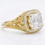 Angled perspective view of a 3 carat Asscher cut lab grown diamond engagement ring in 18K yellow gold with filigree band.