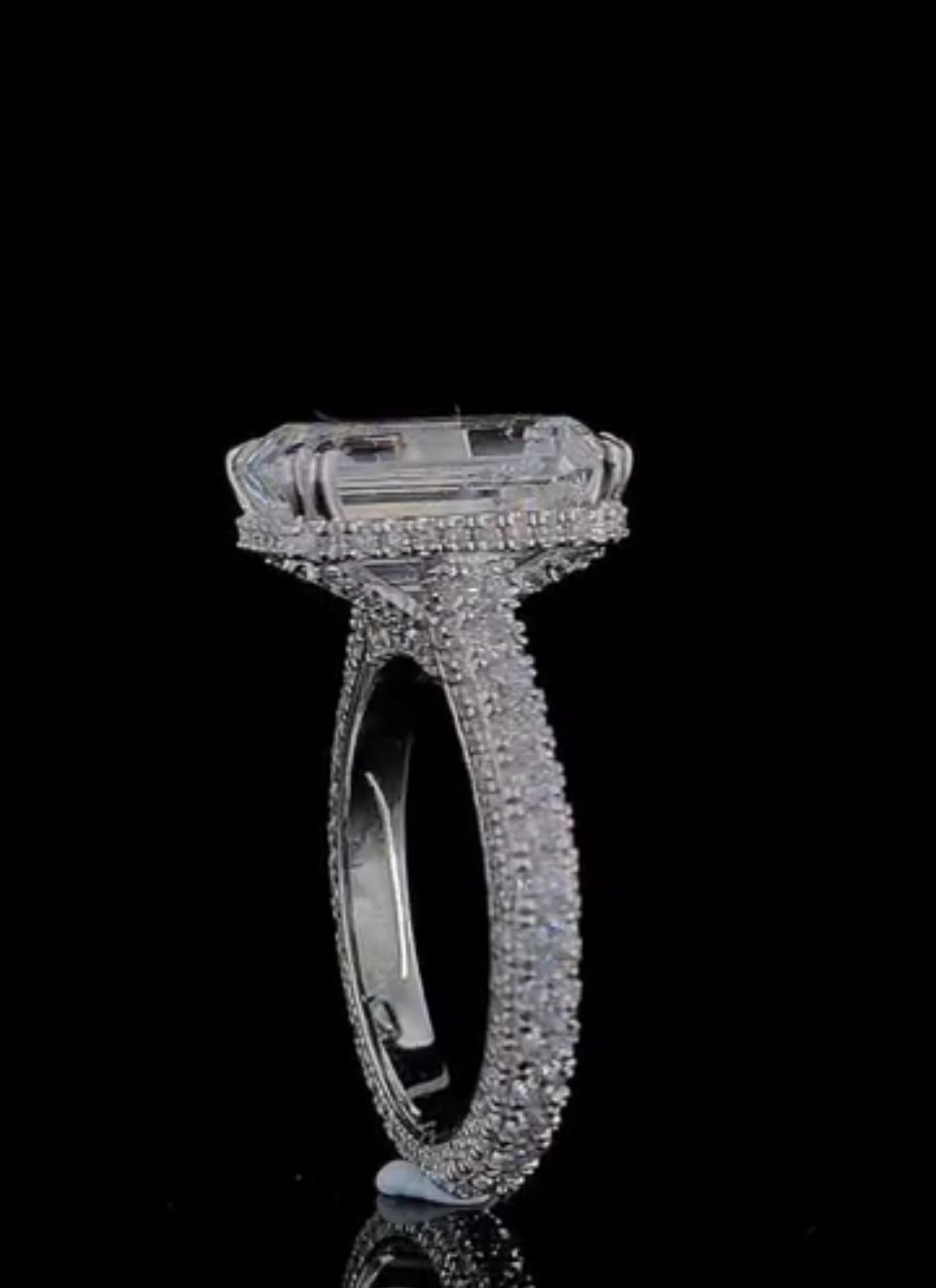 Profile view of 4 CT Emerald Cut Lab Grown Diamond Ring with hidden halo collar and multi-row pavé band
