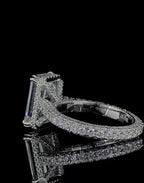Close-up perspective showing the multi-row micro-pavé diamond band on a white gold emerald cut engagement ring