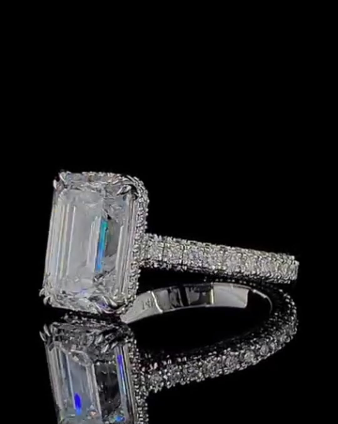 Reflective view showing the clarity of a 4 CT Emerald Cut Lab Diamond with 14K gold hallmark stamp