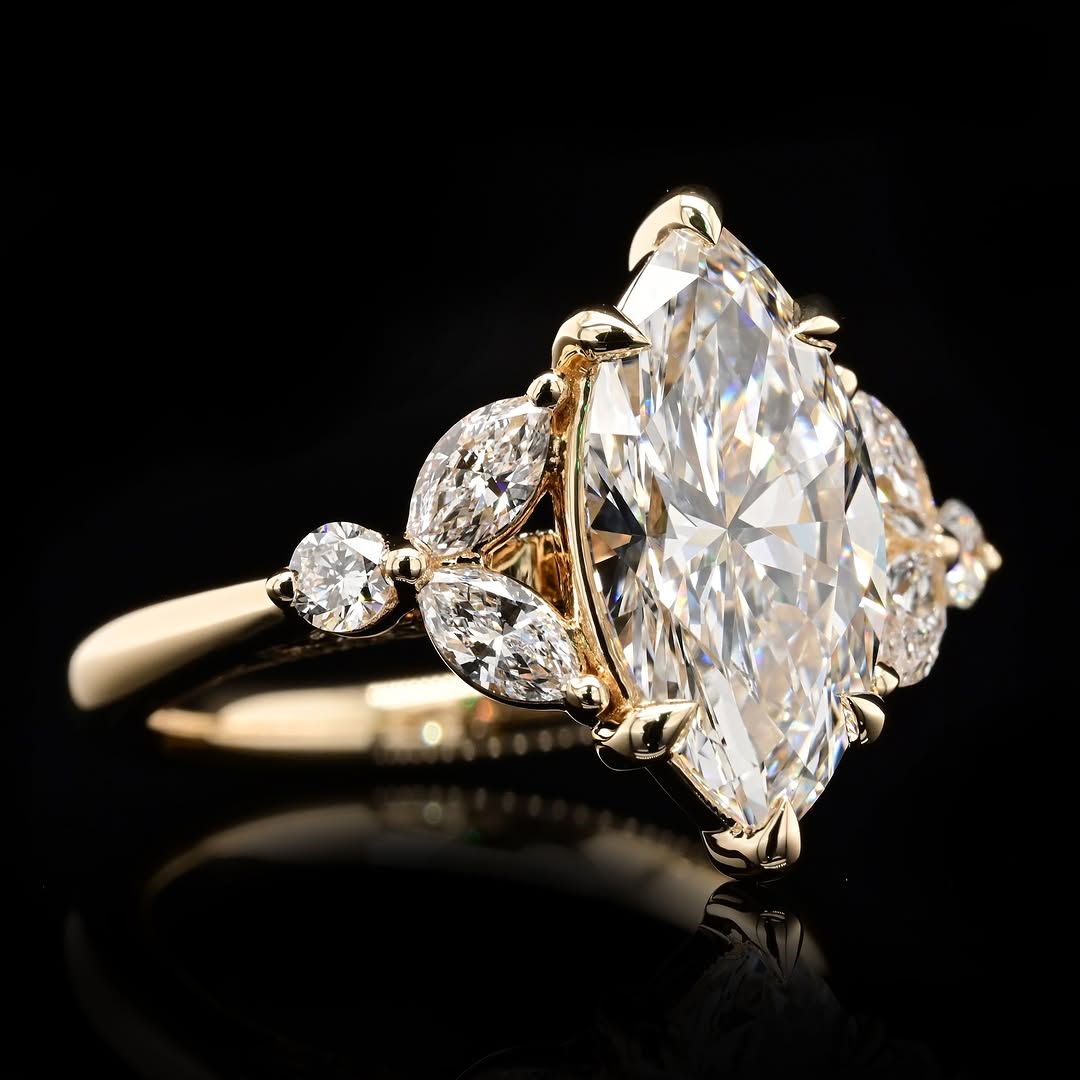 Perspective shot highlighting the fire and brilliance of a 4 CT Marquise Lab Diamond Ring with side stone cluster