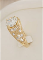 Detailed side view of an antique-style gold ring highlighting the ornate engraved filigree patterns, baguette cuts, and pave diamond details along the band