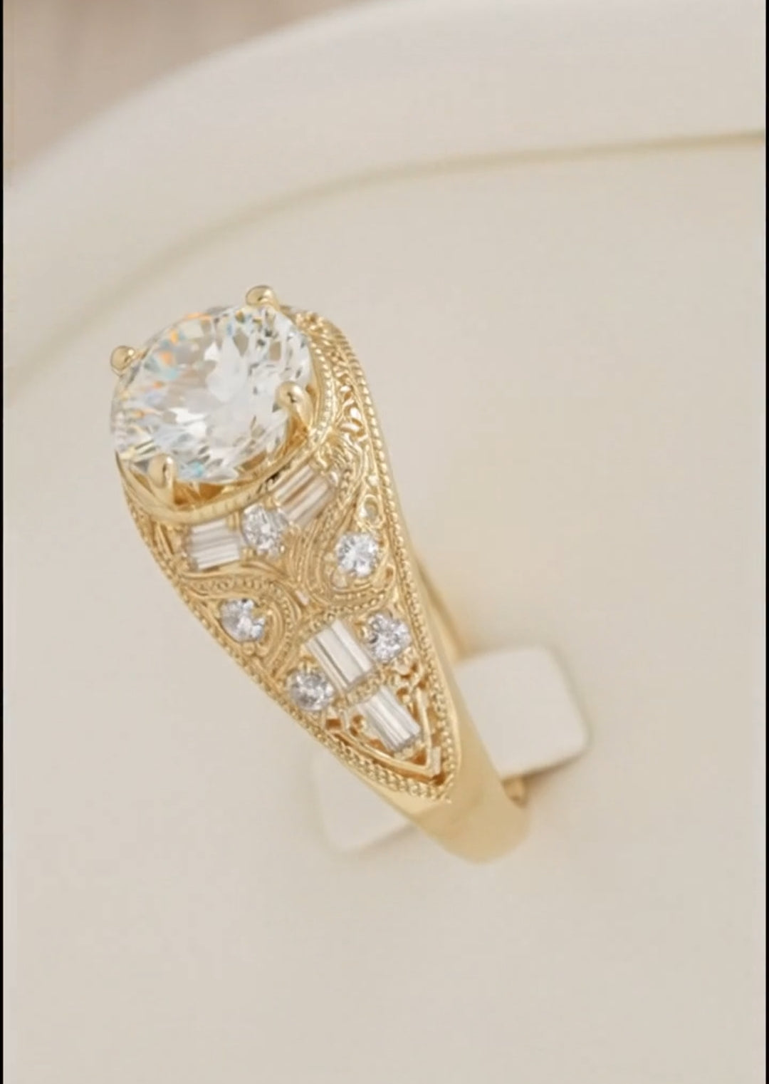 Detailed side view of an antique-style gold ring highlighting the ornate engraved filigree patterns, baguette cuts, and pave diamond details along the band