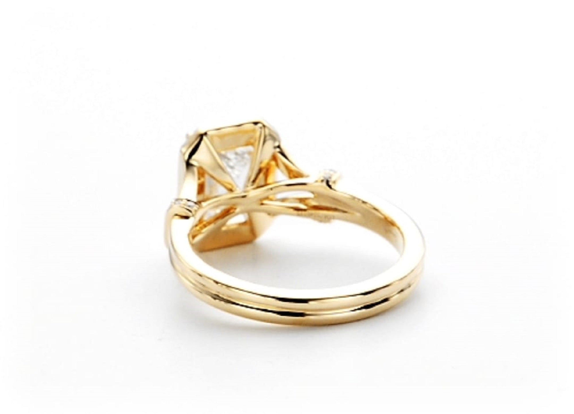 Bottom and side profile of 2 carat emerald cut lab grown diamond ring in 14K yellow gold