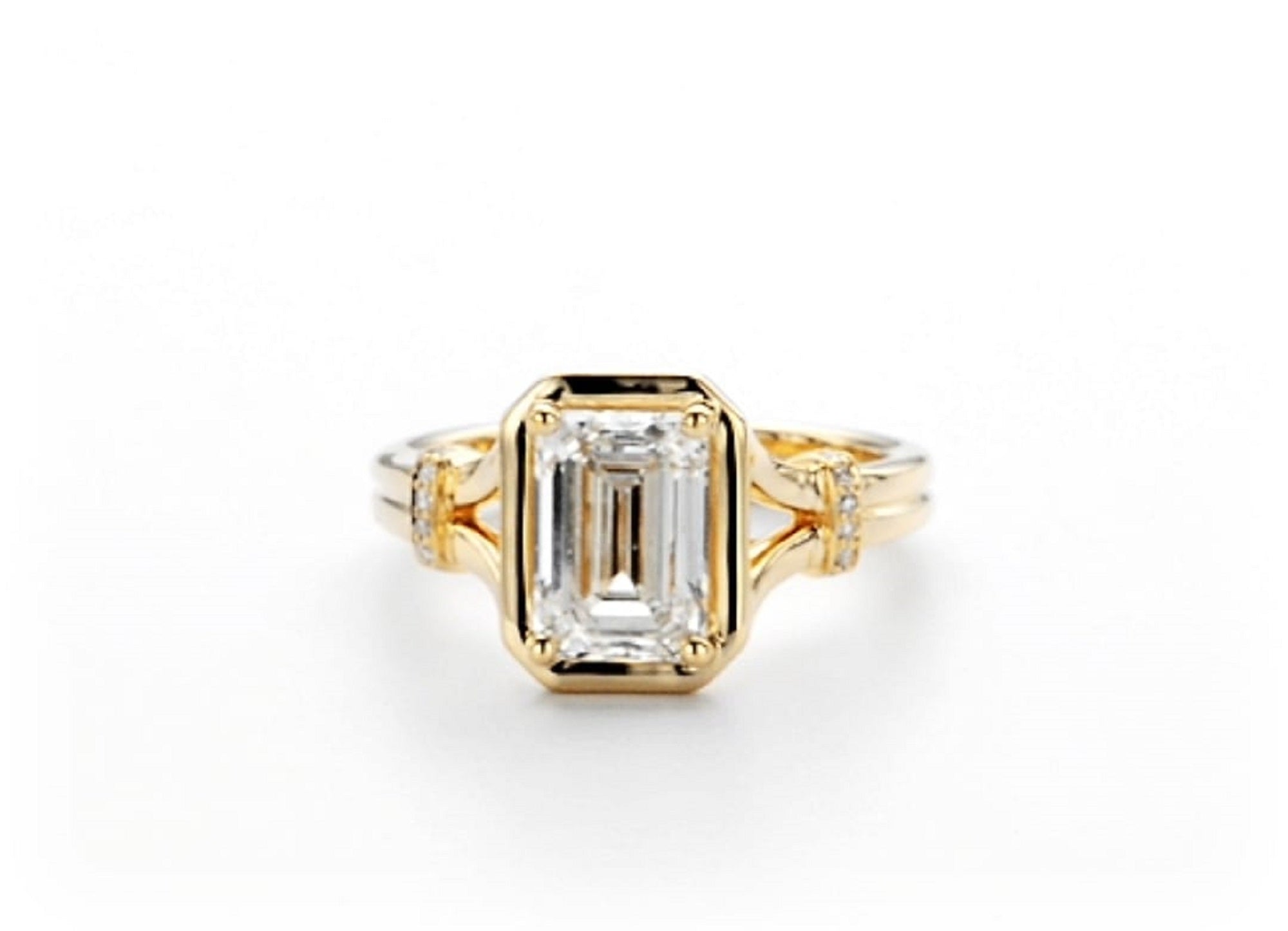 Direct top view of 2 carat emerald cut lab grown diamond ring in a gold bezel setting