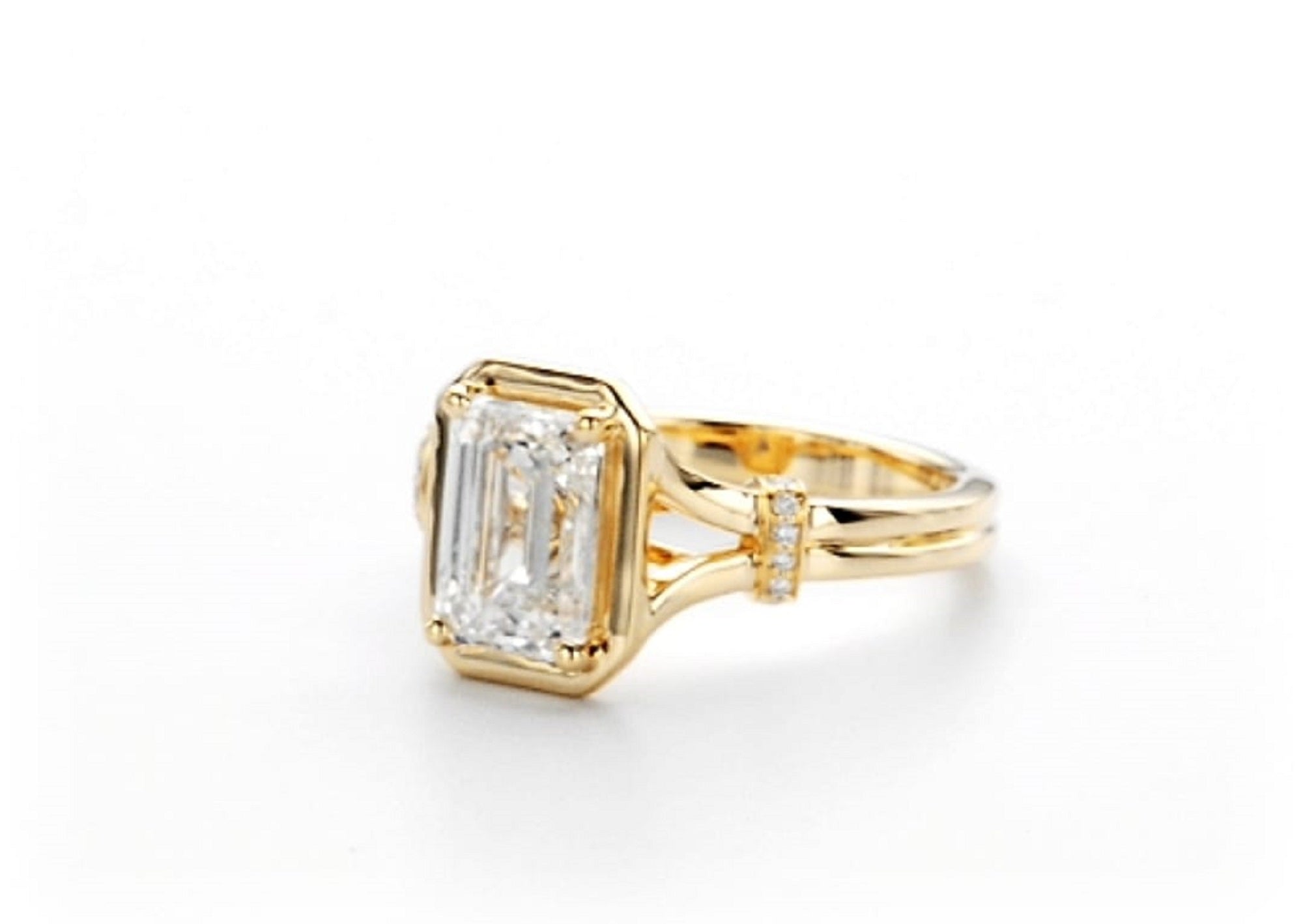 Front perspective view highlighting the emerald cut diamond and split shank band