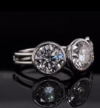 Three-stone round lab grown diamond engagement ring in white gold bezel setting with reflection