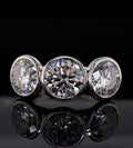 Front view of three brilliant round cut lab grown diamonds set in a full bezel white gold band