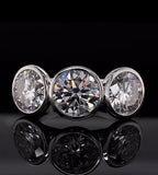 Front view of three brilliant round cut lab grown diamonds set in a full bezel white gold band