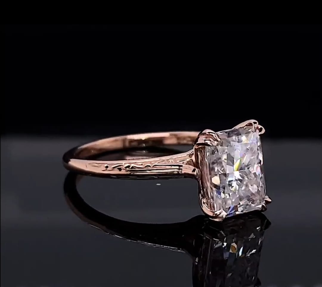 Side angle displaying the intricate vintage floral hand-engraved pattern on the rose gold band