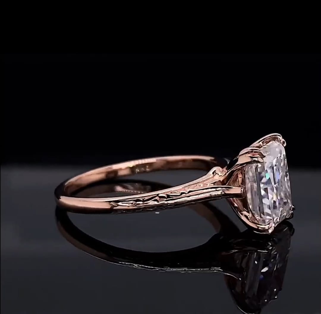 Profile view showcasing the claw prongs, cathedral setting, and engraved shoulder details