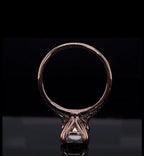 Direct bottom profile shot of the ring standing upright, showing basket architecture and claw prongs