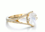 Perspective view showing the brilliant pear diamond and pave split-shank detail in yellow gold