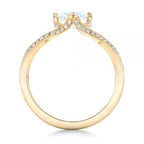 Direct profile view showing the yellow gold band architecture and pave basket gallery