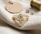 Front view of a 4 CT marquise cut lab grown diamond ring with engraved gold band.