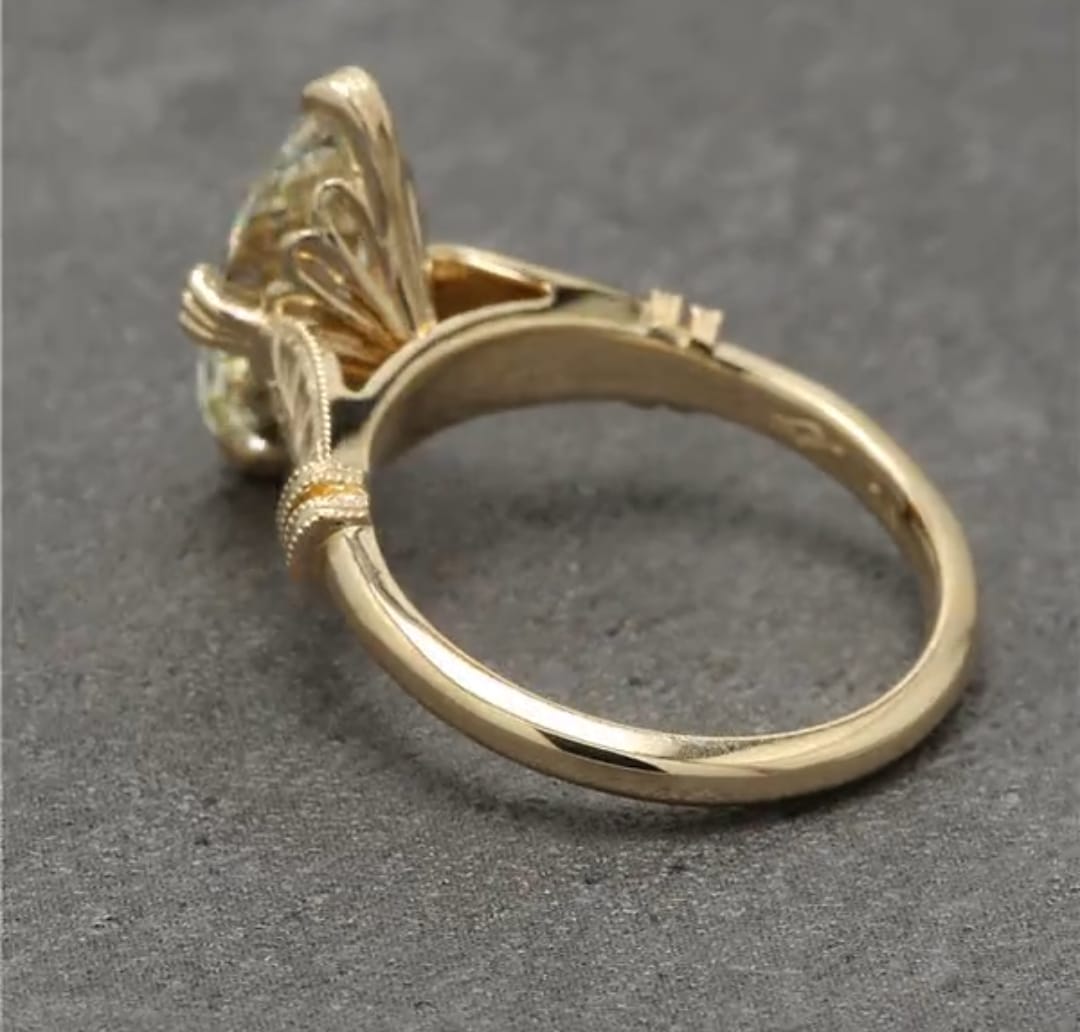 Perspective view highlighting the secure prong setting and carved shoulder accent.