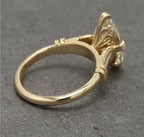High-angle side view of yellow gold marquise lab grown diamond ring.