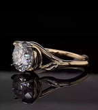 Close-up side profile of yellow gold leaf motif engagement ring with round lab grown diamond.