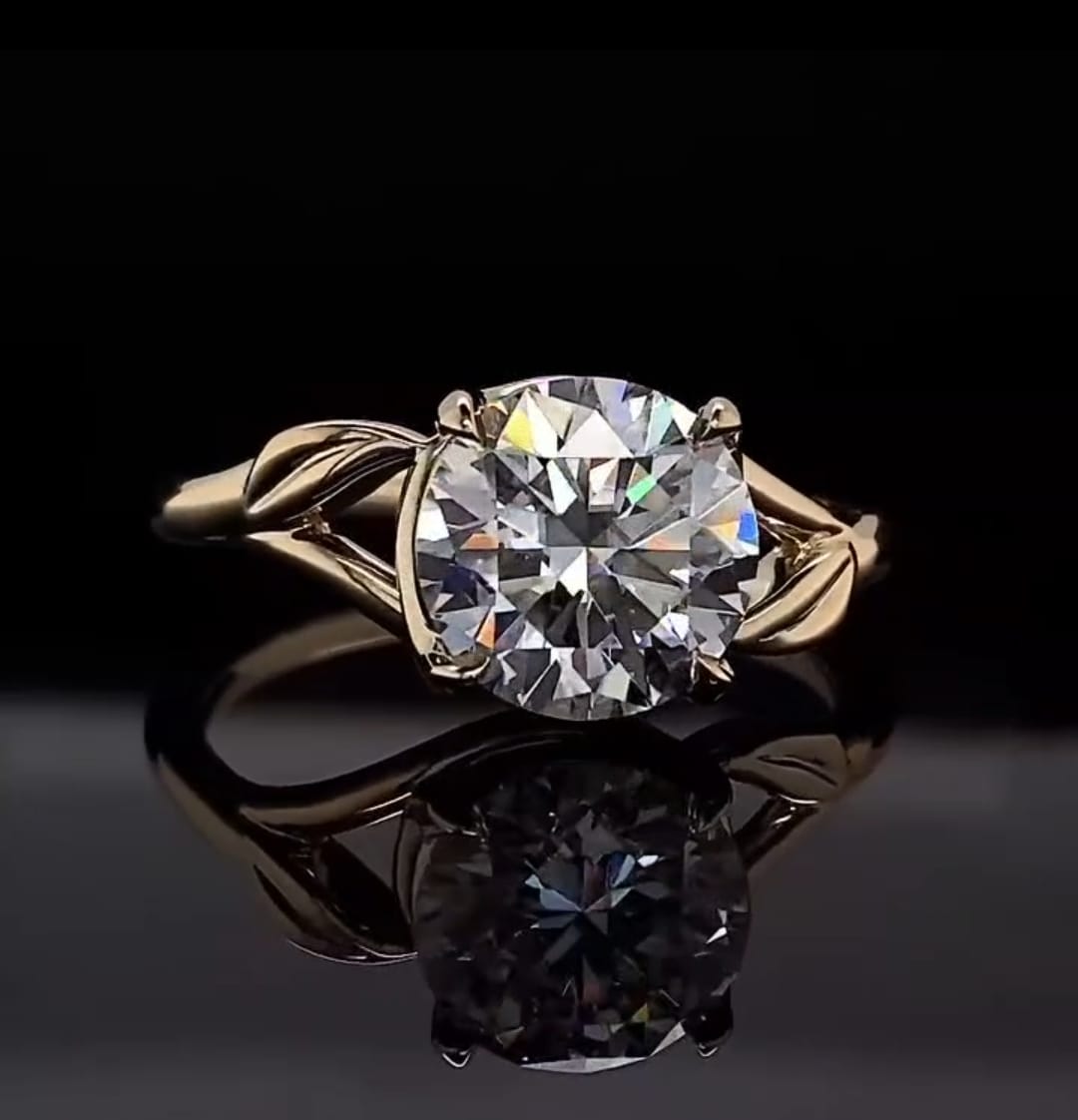 Top-down front view of 3 CT round cut lab grown diamond engagement ring on black reflective background.