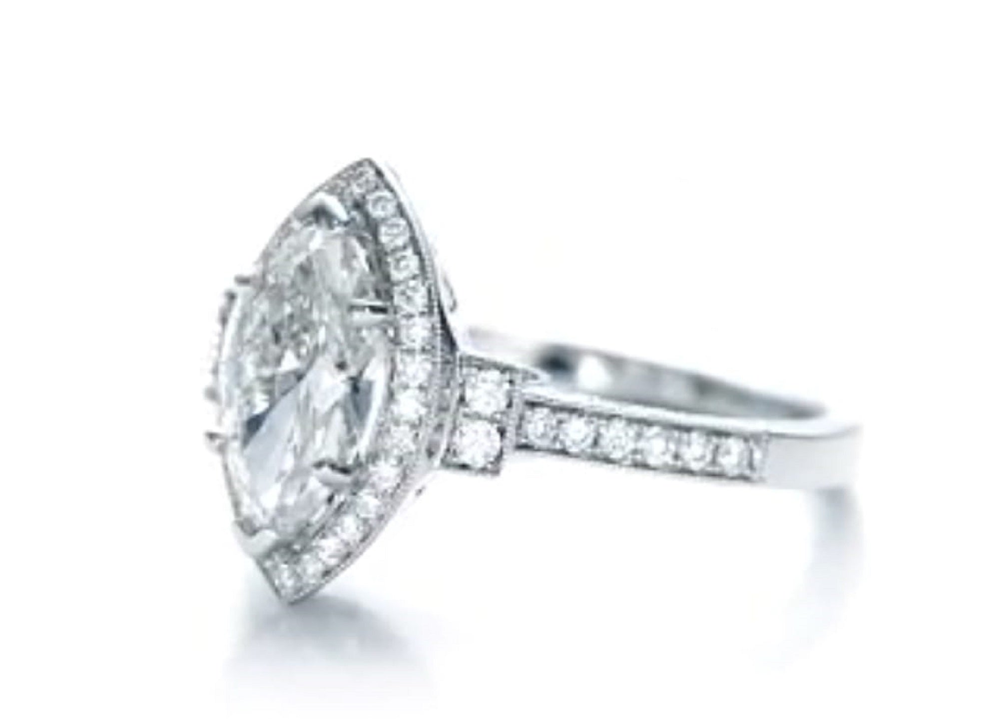 Angled view showcasing the elongated 3 CT marquise lab diamond with milgrain halo setting.
