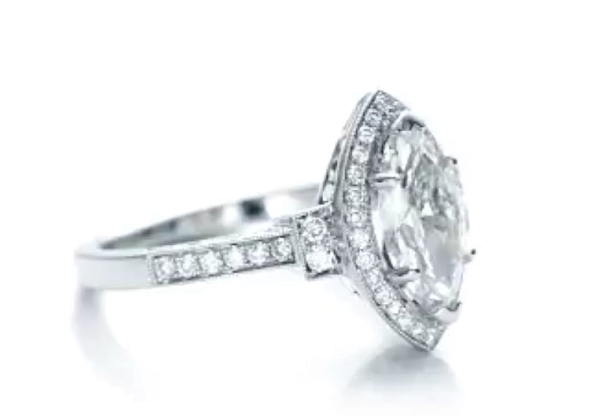 Close-up side profile of marquise halo ring displaying stepped side stone shoulders and pavé shank.