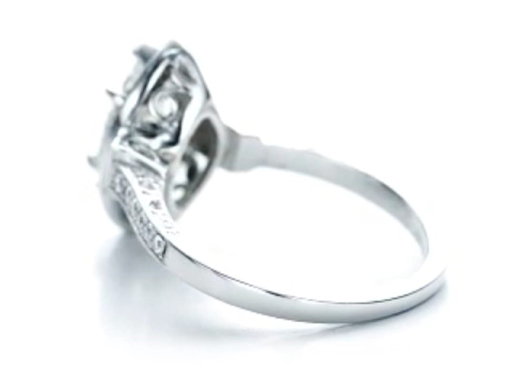 High-angle side view highlighting the intricate scroll filigree under-gallery on white gold band.