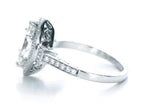 Side angle view highlighting the milgrain detailing, halo structure, and filigree setting.