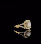 Angled view showing the cushion halo and pave split shank of a 2 CT round lab diamond ring in yellow gold.